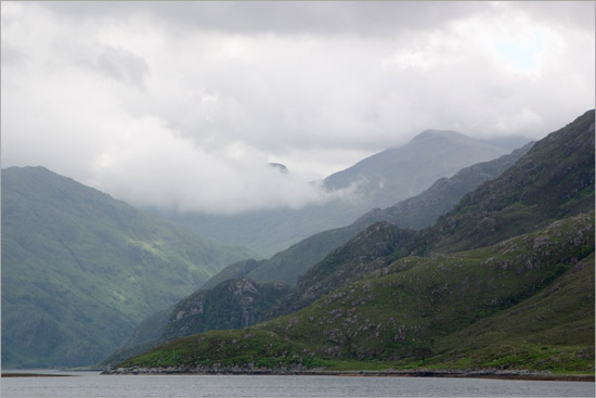 Clouds churning around Sgurr a’ Mhaoraich behind fjord-like inner Loch Hourn; a bit of sunshine on Buidhe Bheinn