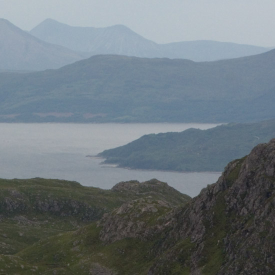 A distant view of the isle of Skye from Slat Bheinn, with An Caisteal in the foreground