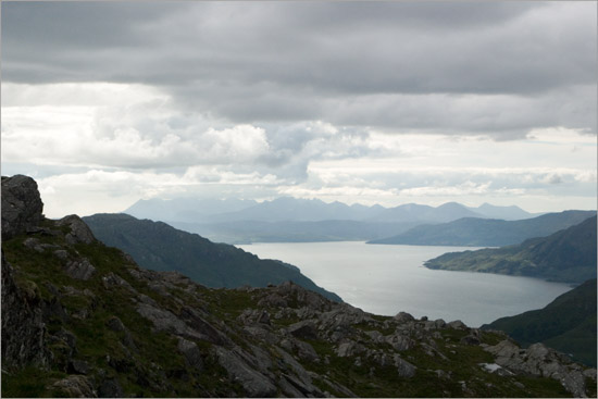 Watching evening clouds from Meall nan Eun, over Loch Hourn and the mountains on the Isle of Skye