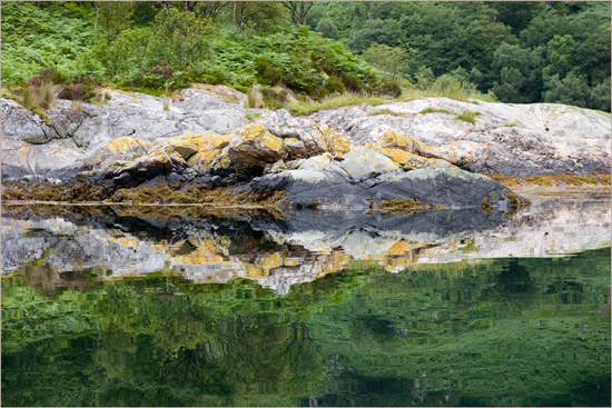 Eilean Mhogh-sgeir mirrored in Loch Hourn